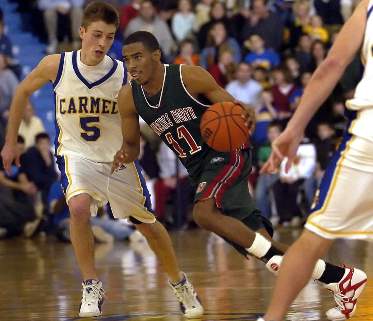 Lawrence North's Mike Conley drives by by Carmel's Brett Finkelmeier.